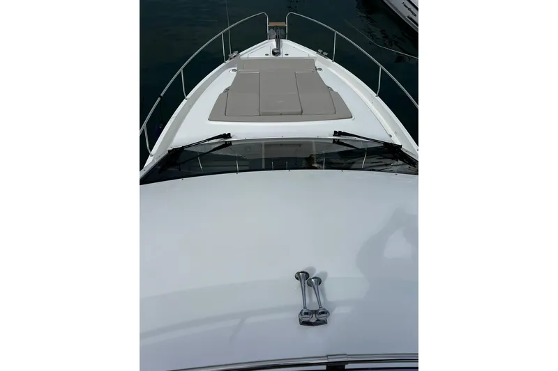 Sealine F430 Yacht Photos Pics 2020 Sealine F430 yacht bow with sunpad and railing, docked in marina.
