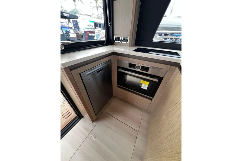 Sealine F430 Yacht Photos Pics Modern kitchen area in 2020 Sealine F430 yacht with sleek appliances and wood finish.
