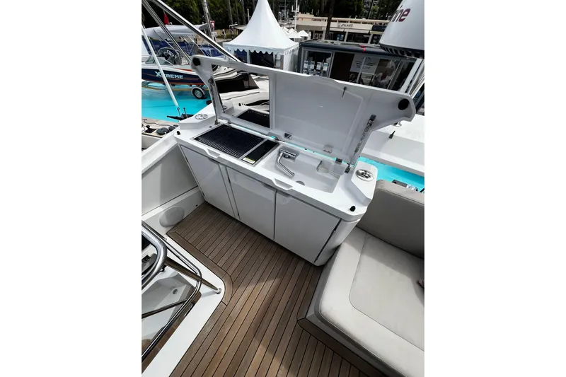 Sealine F430 Yacht Photos Pics 2020 Sealine F430 yacht deck with open kitchenette and seating area.