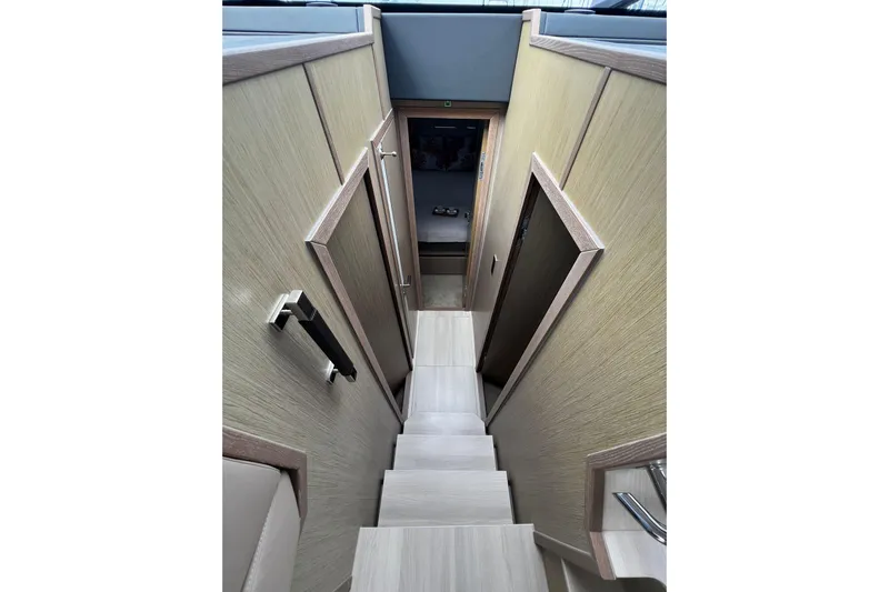 Sealine F430 Yacht Photos Pics Staircase inside 2020 Sealine F430 yacht, featuring modern wood paneling and sleek design.
