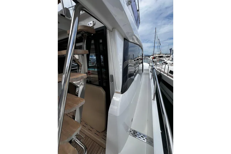 Sealine F430 Yacht Photos Pics 2020 Sealine F430 yacht with sleek exterior and wooden steps, docked at a marina.