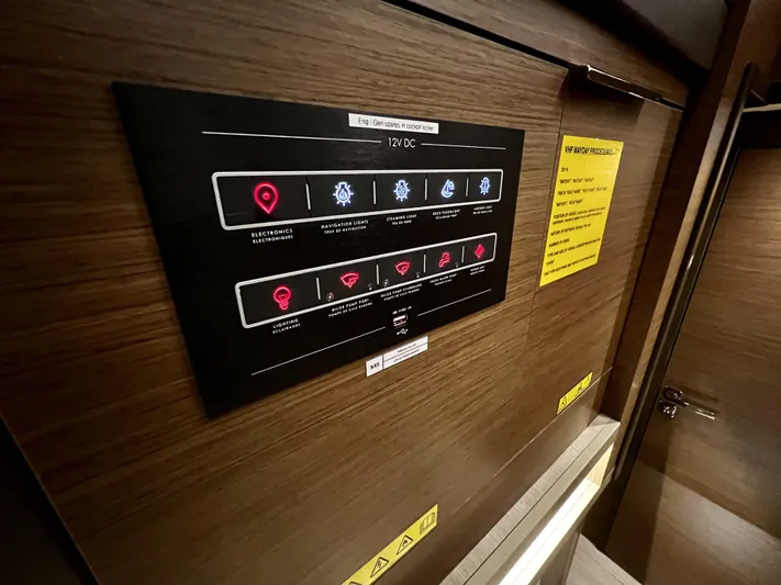 Echo Yacht Photos Pics Control panel inside 2023 Lagoon 50 yacht, featuring various system indicators and instructions.