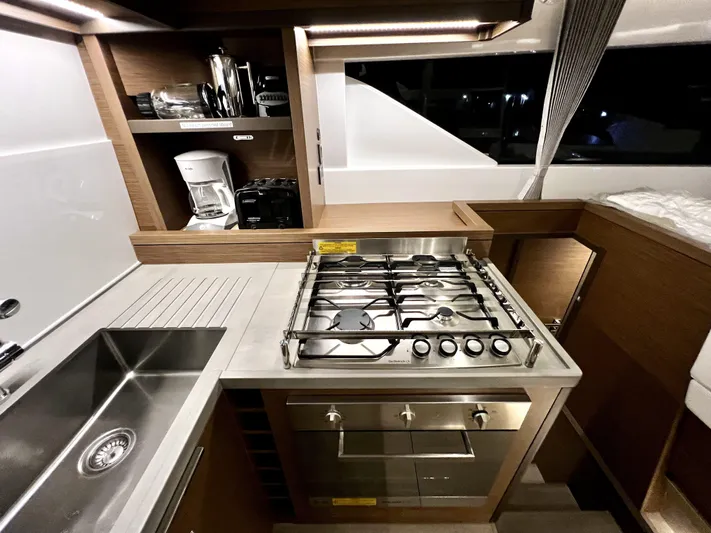 Echo Yacht Photos Pics Modern kitchen in 2023 Lagoon 50 yacht with stove, sink, and appliances.