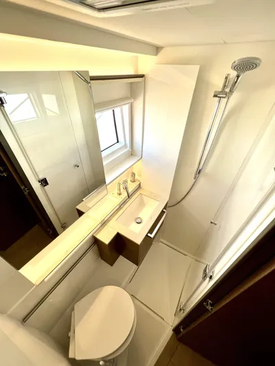 Echo Yacht Photos Pics 2023 Lagoon 50 yacht bathroom with modern fixtures, shower, and sleek design.