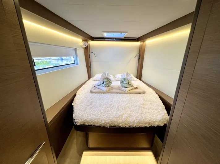 Echo Yacht Photos Pics Luxurious cabin interior of 2023 Lagoon 50 yacht with cozy bed and ambient lighting.