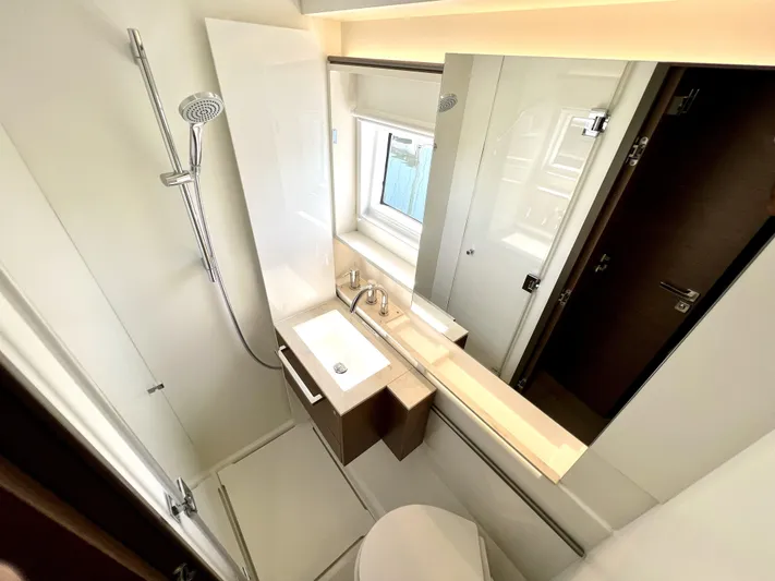 Echo Yacht Photos Pics Modern bathroom in 2023 Lagoon 50 yacht, featuring sleek fixtures and a compact design.