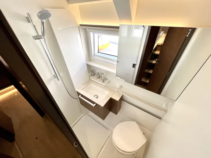 Echo Yacht Photos Pics Modern bathroom in 2023 Lagoon 50 yacht with shower, sink, and toilet.