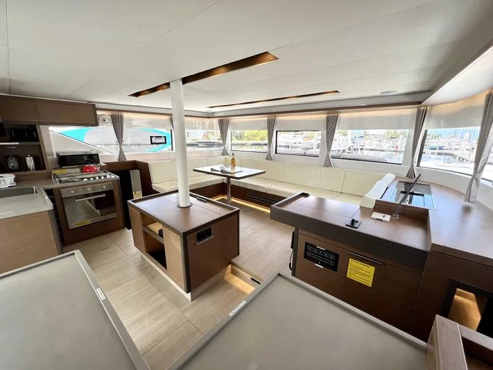 Echo Yacht Photos Pics 2023 Lagoon 50 yacht interior with modern kitchen and spacious seating area.