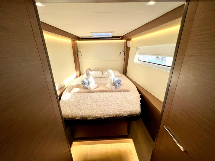 Echo Yacht Photos Pics Luxurious cabin interior of 2023 Lagoon 50 yacht with cozy bedding and ambient lighting.