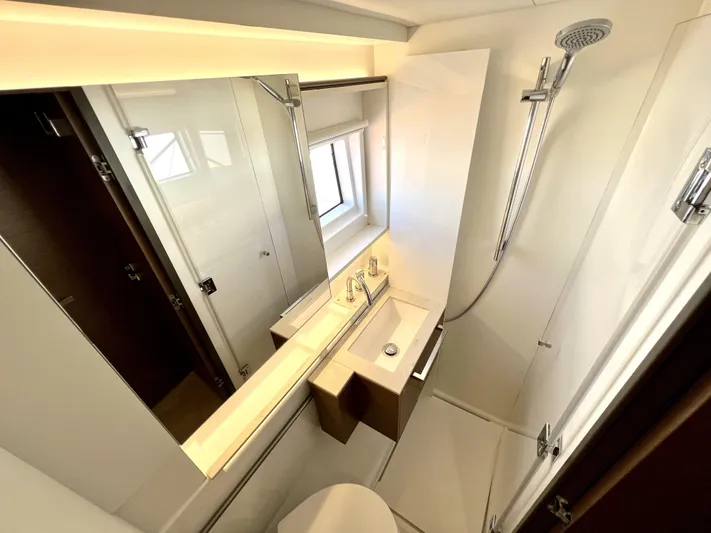 Echo Yacht Photos Pics Modern bathroom in 2023 Lagoon 50 yacht, featuring sleek fixtures and a spacious shower area.