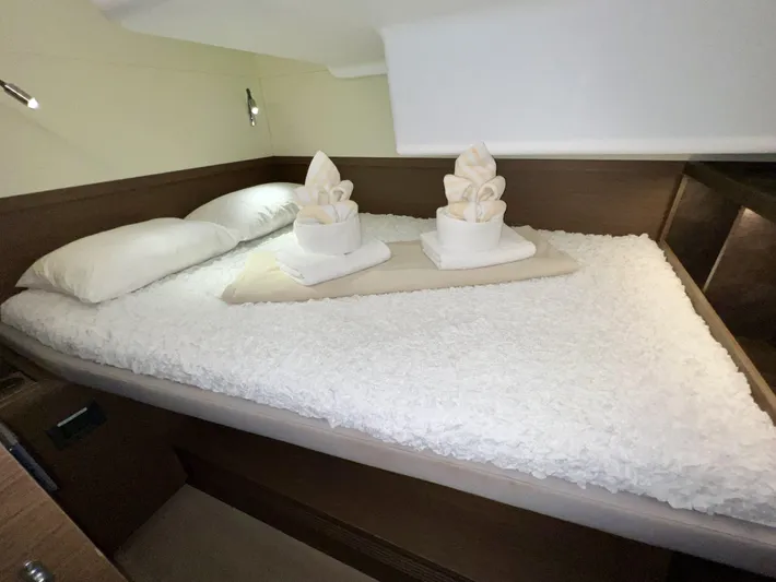 Echo Yacht Photos Pics Luxurious cabin interior of 2023 Lagoon 50 yacht with neatly arranged bed linens.