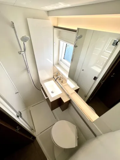 Echo Yacht Photos Pics Modern bathroom in 2023 Lagoon 50 yacht with shower, sink, and toilet.