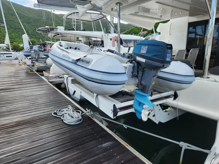 Echo Yacht Photos Pics 2023 Lagoon 50 catamaran docked with inflatable dinghy and outboard motor.
