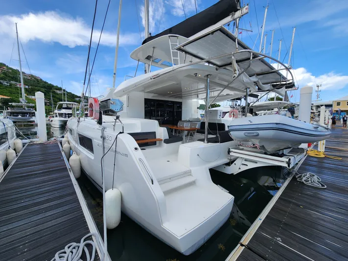 Echo Yacht Photos Pics 2023 Lagoon 50 catamaran docked at marina, featuring spacious deck and modern design.