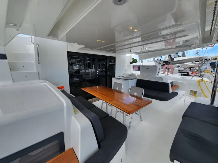 Echo Yacht Photos Pics 2023 Lagoon 50 yacht interior with sleek seating and wooden table.