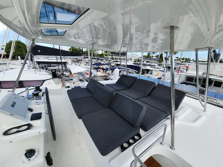 Echo Yacht Photos Pics 2023 Lagoon 50 yacht with spacious deck, modern seating, and marina view.