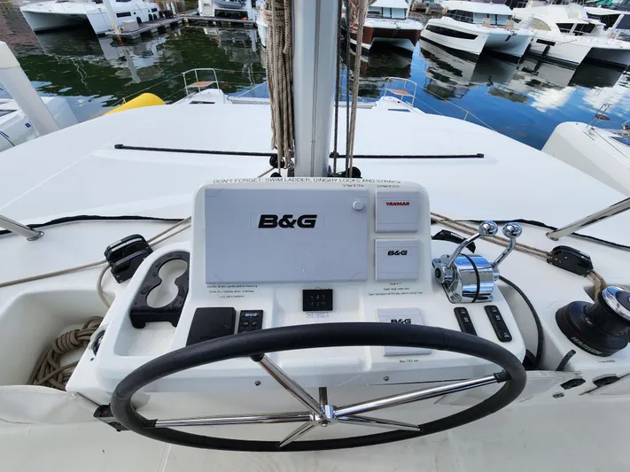 Echo Yacht Photos Pics 2023 Lagoon 50 yacht helm with B&G navigation system, docked at marina.