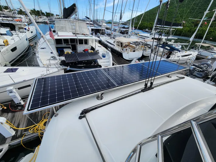 Echo Yacht Photos Pics 2023 Lagoon 50 catamaran with solar panels docked at a marina.