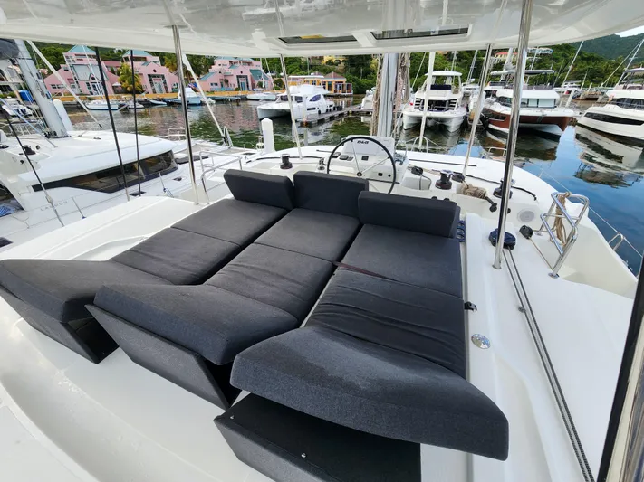 Echo Yacht Photos Pics 2023 Lagoon 50 yacht with spacious deck seating in a marina setting.