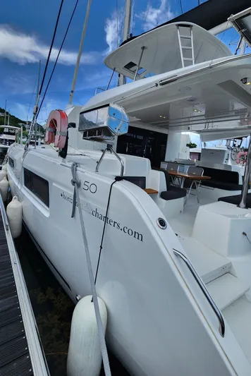 Echo Yacht Photos Pics 2023 Lagoon 50 catamaran docked, showcasing sleek design and spacious deck.