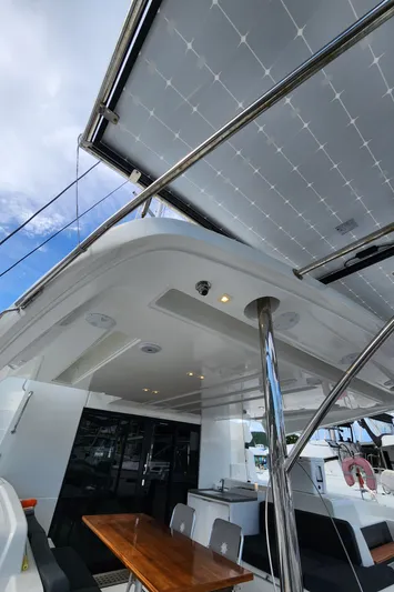 Echo Yacht Photos Pics 2023 Lagoon 50 yacht with solar panels and outdoor seating area.