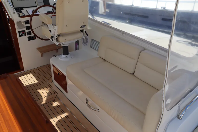 Rambler VIII Yacht Photos Pics 2013 MJM 36z Downeast boat interior with beige seating and wooden flooring.