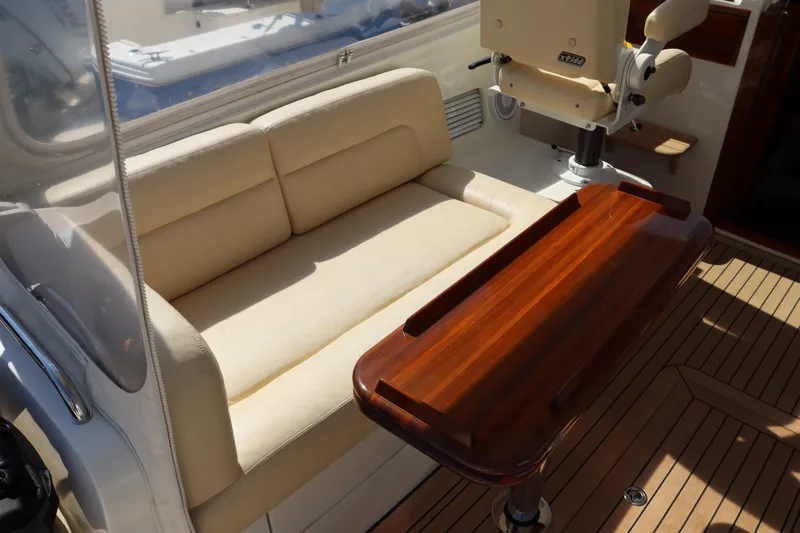 Rambler VIII Yacht Photos Pics Luxury seating area on 2013 MJM 36z Downeast yacht with wooden table.