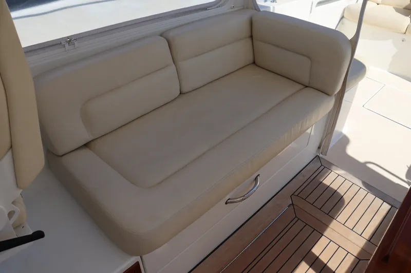 Rambler VIII Yacht Photos Pics 2013 MJM 36z Downeast boat interior with beige cushioned seating and wooden flooring.