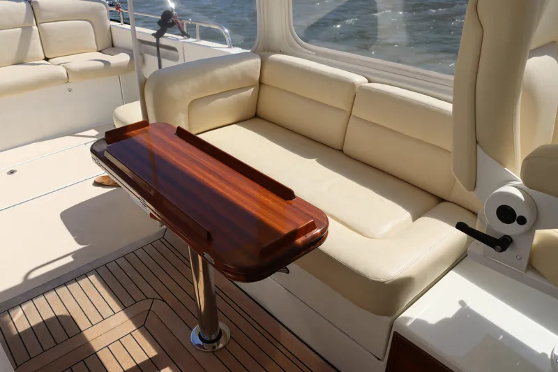 Rambler VIII Yacht Photos Pics Luxurious seating area on 2013 MJM 36z Downeast boat with wooden table.