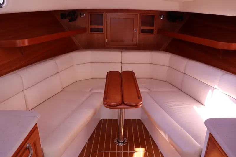 Rambler VIII Yacht Photos Pics Luxurious interior of 2013 MJM 36z Downeast yacht with white seating and wooden accents.