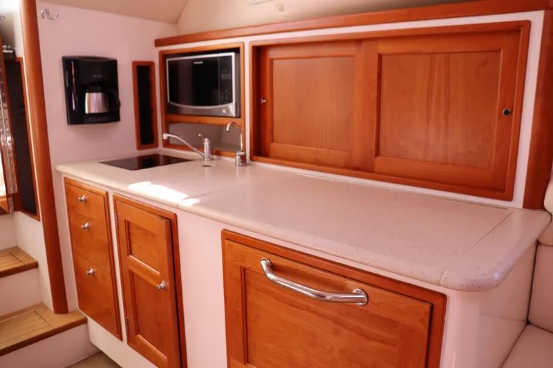 Rambler VIII Yacht Photos Pics 2013 MJM 36z Downeast yacht kitchen with wood cabinetry and modern appliances.
