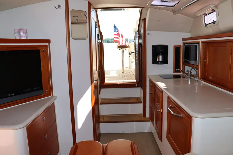 Rambler VIII Yacht Photos Pics Interior of 2013 MJM 36z Downeast yacht with kitchen and seating area.