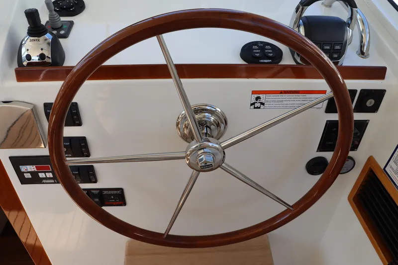 Rambler VIII Yacht Photos Pics Steering wheel of 2013 MJM 36z Downeast boat with control panel.