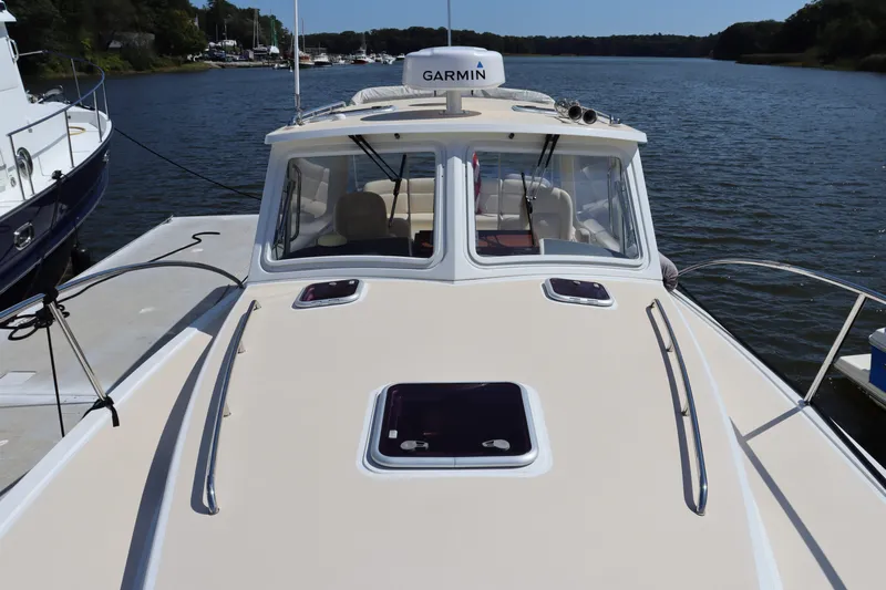 Rambler VIII Yacht Photos Pics 2013 MJM 36z Downeast boat docked on a calm river with Garmin equipment.