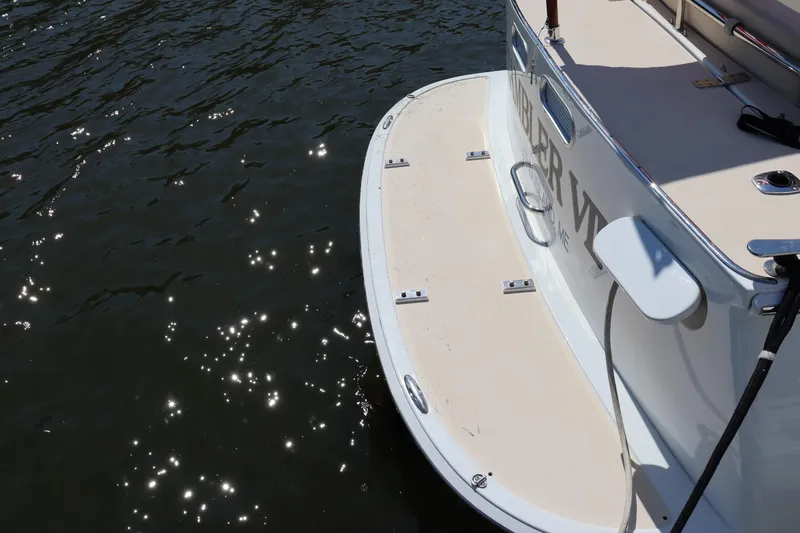 Rambler VIII Yacht Photos Pics 2013 MJM 36z Downeast boat stern with swim platform on sparkling water.