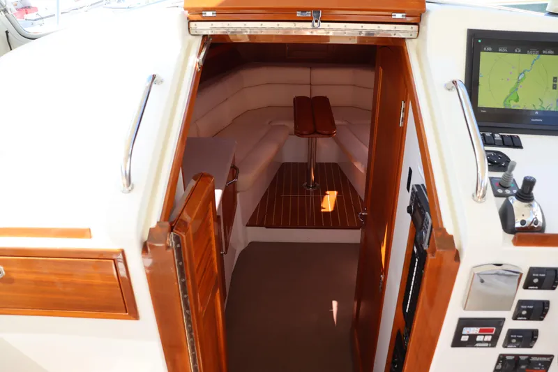 Rambler VIII Yacht Photos Pics Interior cabin of 2013 MJM 36z Downeast boat with wood accents and navigation equipment.