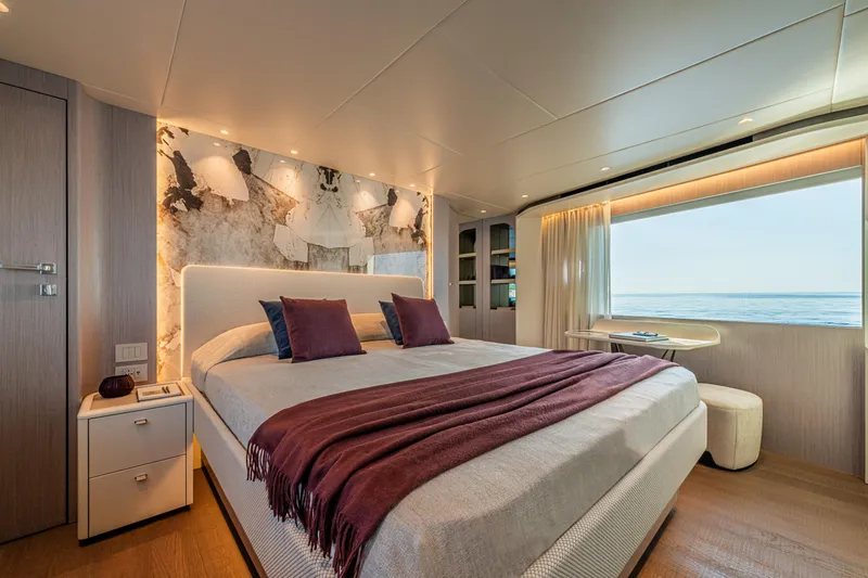  Yacht Photos Pics Luxurious bedroom interior of 2026 Absolute Navetta 62 yacht with ocean view.