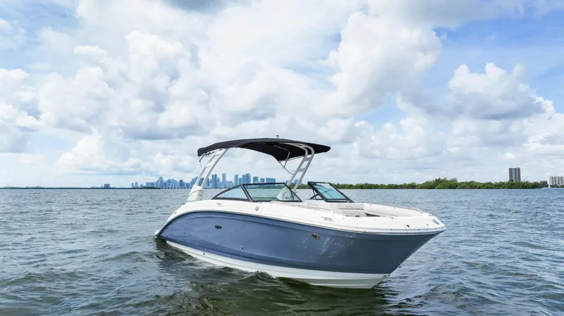  Yacht Photos Pics 2023 Sea Ray SDX 270 Outboard boat on open water with city skyline.