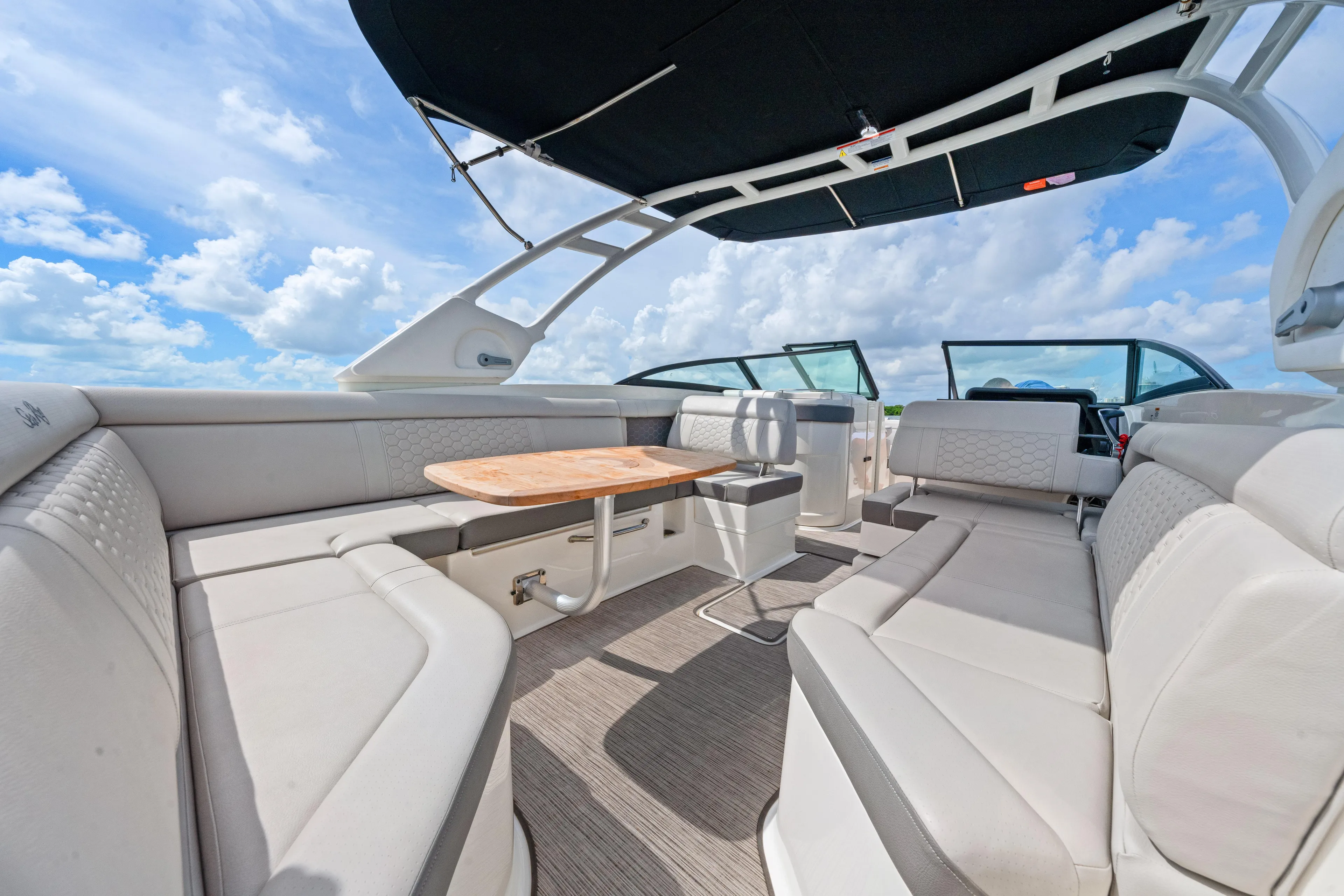  Yacht Photos Pics Luxurious interior of 2023 Sea Ray SDX 270 Outboard boat with spacious seating and table.