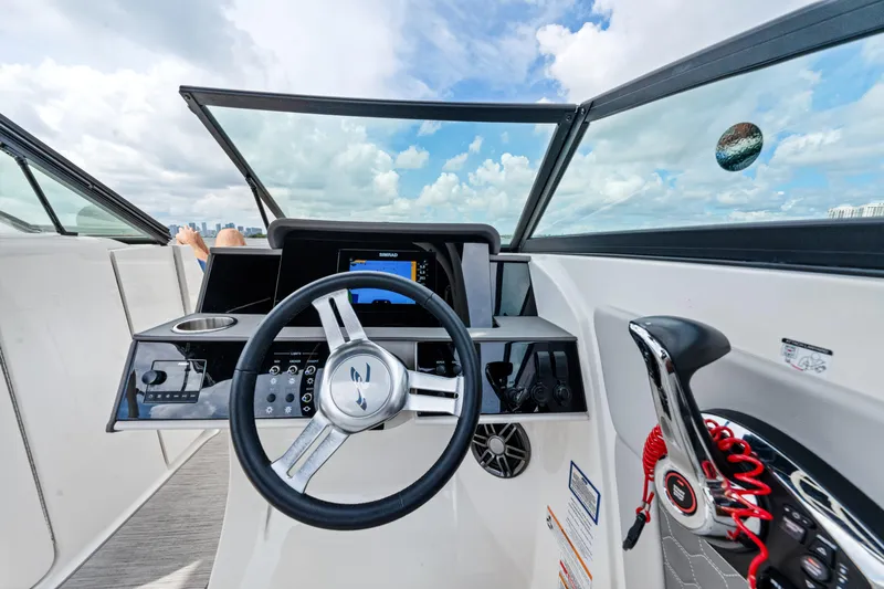  Yacht Photos Pics 2023 Sea Ray SDX 270 Outboard dashboard with steering wheel and controls, under a blue sky.