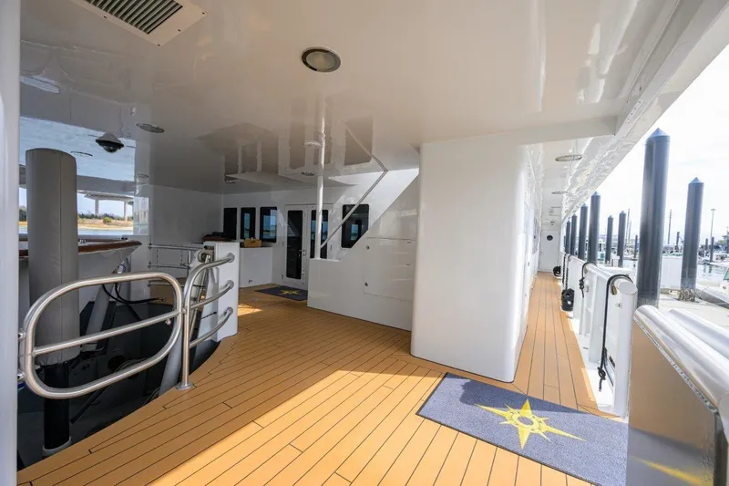 Compass Rose Yacht Photos Pics Spacious deck of 2011 C & G Boatworks Explorer with wooden flooring and modern design.