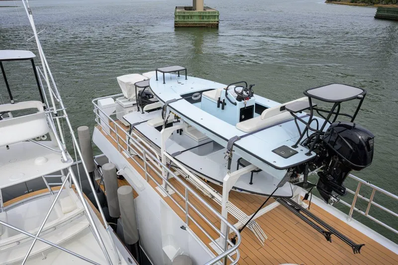 Compass Rose Yacht Photos Pics 2011 C & G Boatworks Explorer docked, featuring sleek design and powerful outboard motor.