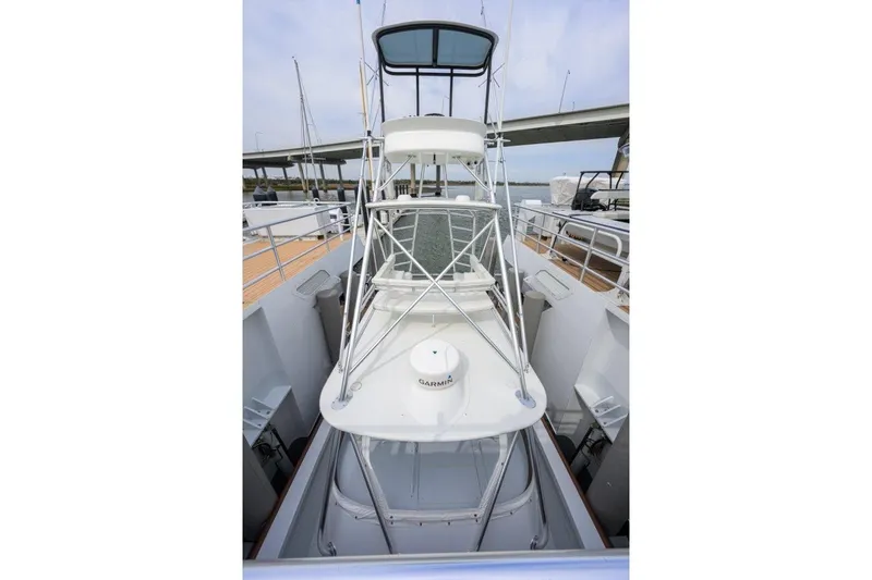 Compass Rose Yacht Photos Pics 2011 C & G Boatworks Explorer with tower, docked near a bridge.