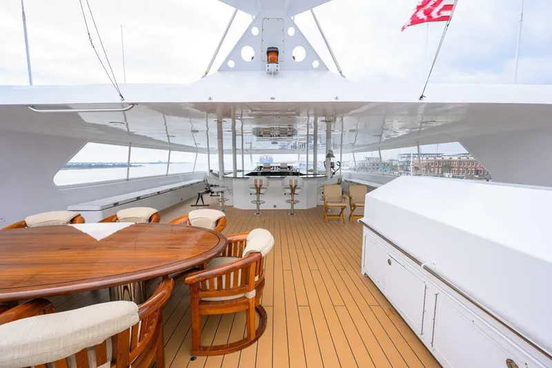 Compass Rose Yacht Photos Pics Luxurious 2011 C & G Boatworks Explorer yacht deck with seating and dining area.