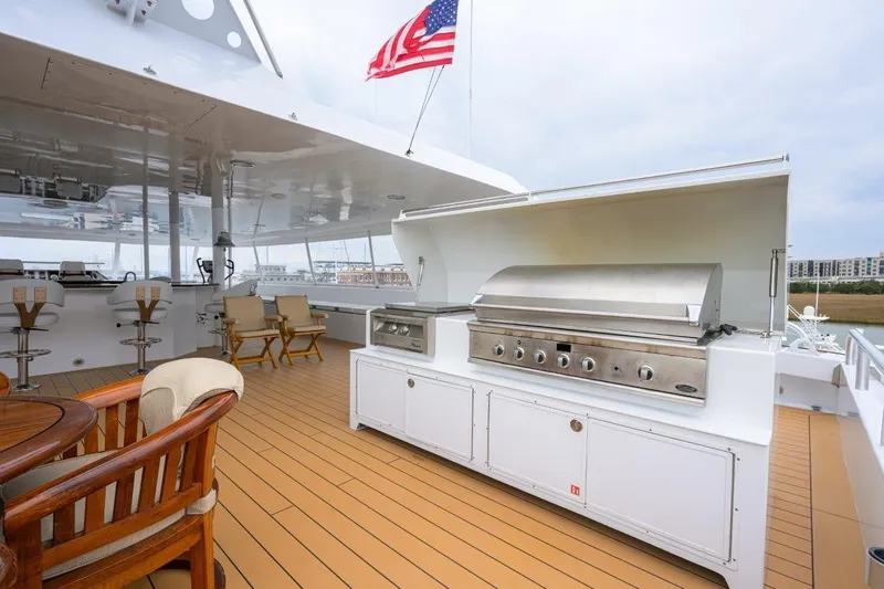 Compass Rose Yacht Photos Pics Luxury yacht deck with grill, seating, and American flag; 2011 C & G Boatworks Explorer.