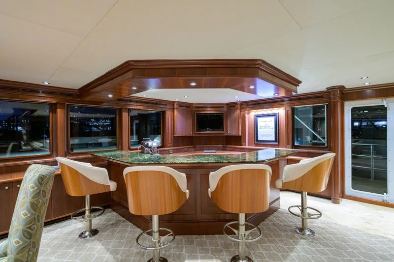 Compass Rose Yacht Photos Pics Luxurious yacht interior with wooden bar and swivel chairs, C & G Boatworks Explorer 2011.