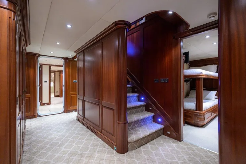 Compass Rose Yacht Photos Pics Luxurious interior of 2011 C & G Boatworks Explorer with wooden paneling and carpeted stairs.