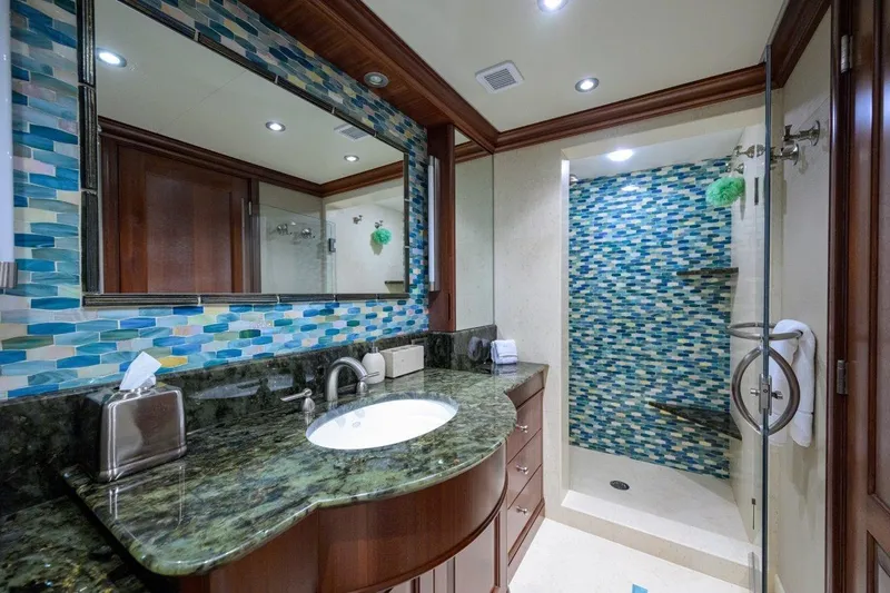 Compass Rose Yacht Photos Pics Luxurious yacht bathroom with mosaic tiles, granite countertop, and glass shower in 2011 C & G Boatworks Explorer.