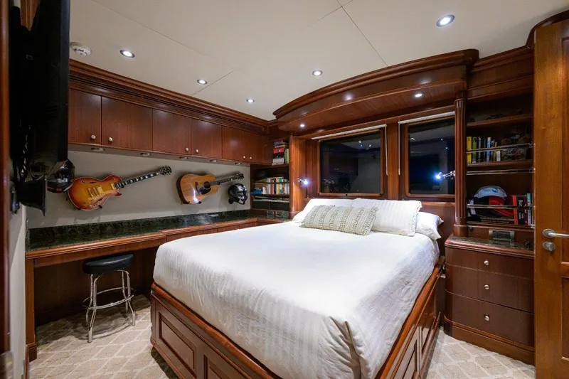 Compass Rose Yacht Photos Pics Luxurious 2011 C & G Boatworks Explorer bedroom with guitars, wood cabinetry, and cozy lighting.