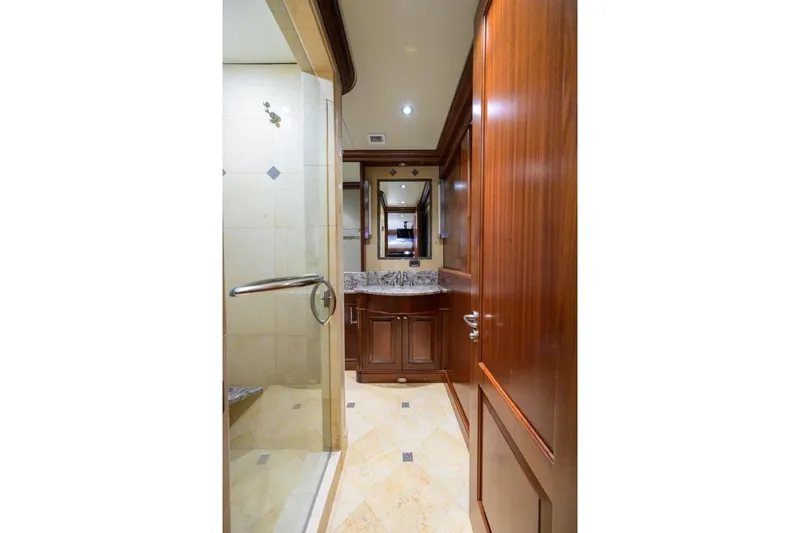 Compass Rose Yacht Photos Pics Luxurious bathroom interior of 2011 C & G Boatworks Explorer yacht, featuring wood cabinetry and marble accents.